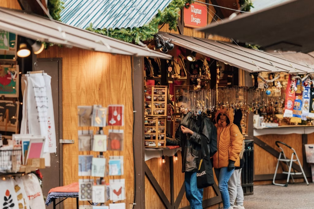 Two people checking out products at a booth in Market Square.